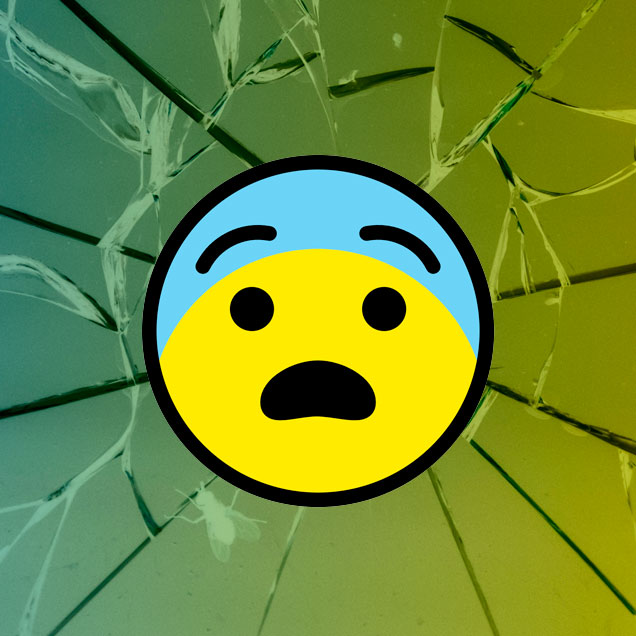 Emoji con cara de sorpresa sobre fondo de un vidrio roto.